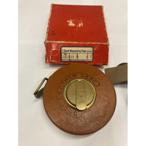 128 - A VINTAGE LEATHER TAPE MEASURE IN ORIGINAL BOX MARKED WEST GERMANY PLUS A VINTAGE WEIGHING DEVICE MA... 