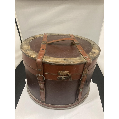 132 - A ROUND LEATHER AND BRASS BOX - POSSIBLY A HAT BOX