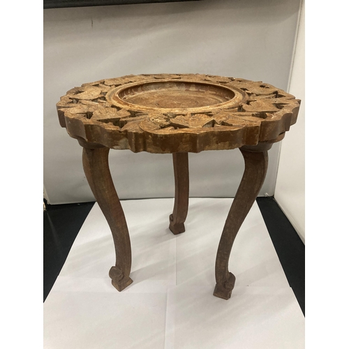 135 - AN ASIAN STYLE SMALL WOODEN TABLE WITH CARVED DECORATION HEIGHT 32CM