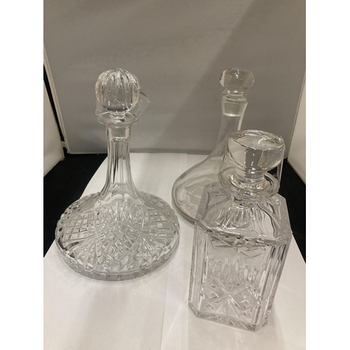 142 - THREE GLASS DECANTERS TO INCLUDE TWO SHIPS DECANTERS