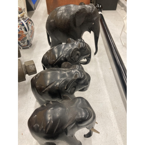 206 - A COLLECTION OF HARDWOOD CARVED ELEPHANTS IN VARYING SIZES - 10 IN TOTAL