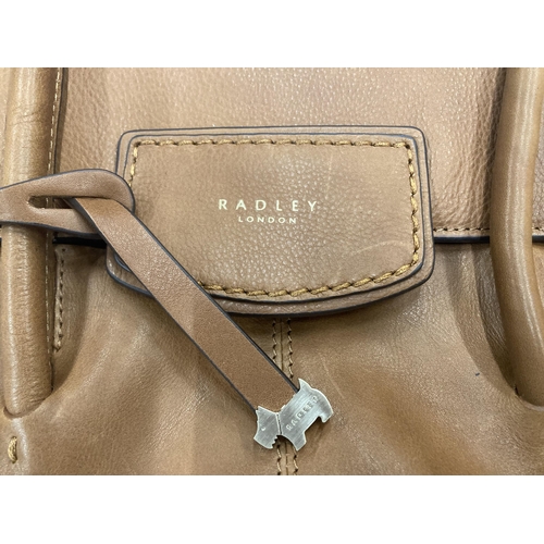 233 - A VINTAGE TAN COLOURED RADLEY BAG WITH COVER