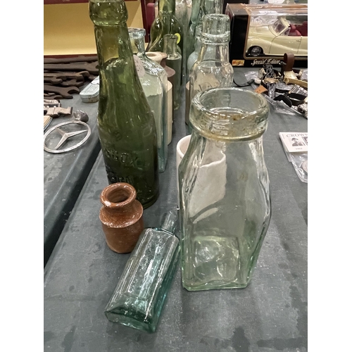 283 - A LARGE QUANTITY OF VINTAGE GLASS BOTTLES TO INCLUDE ADVERTISING ONES