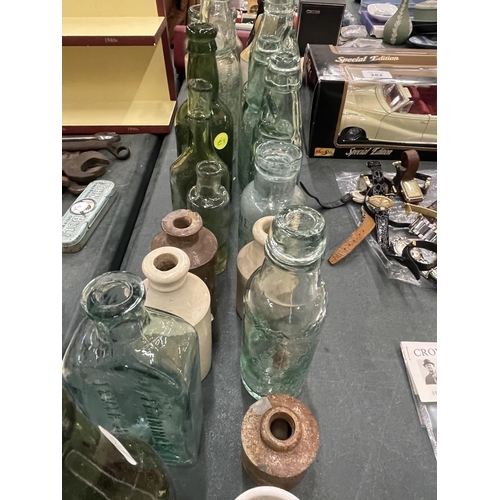 283 - A LARGE QUANTITY OF VINTAGE GLASS BOTTLES TO INCLUDE ADVERTISING ONES