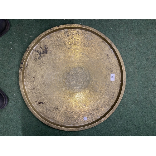 86 - A LARGE MIDDLE EASTERN BRASS CHARGER, DIAMETER 56CM