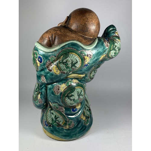 391 - A LARGE JAPANESE MEIJI PERIOD (1868-1912) POTTERY MODEL OF HOTEI WEARING CHINESE DRAGON DESIGN ROBE,... 