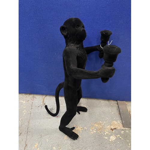 121 - A FLOCK COVERED 'MONKEY' CANDLE HOLDER HEIGHT 53CM