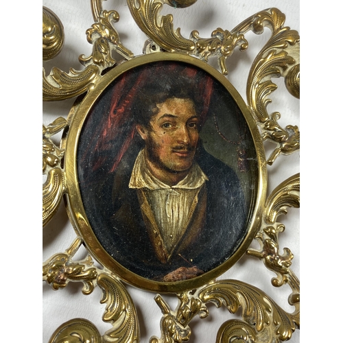 9 - AN ORNATE BRASS FRAMED BYRONESQUE OIL PORTRAIT MINIATURE, LENGTH 14CM