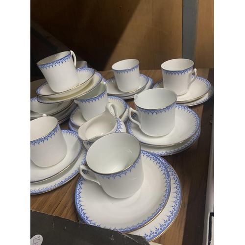 1162 - A QUANTITY OF CHINA CUPS, SAUCERS, SIDE PLATES, A SUGAR BOWL AND CREAM JUG