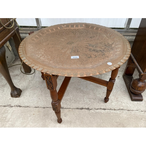 2229 - AN ASIAN FOLDING TABLE WITH EMBOSSED COPPER TOP, 24