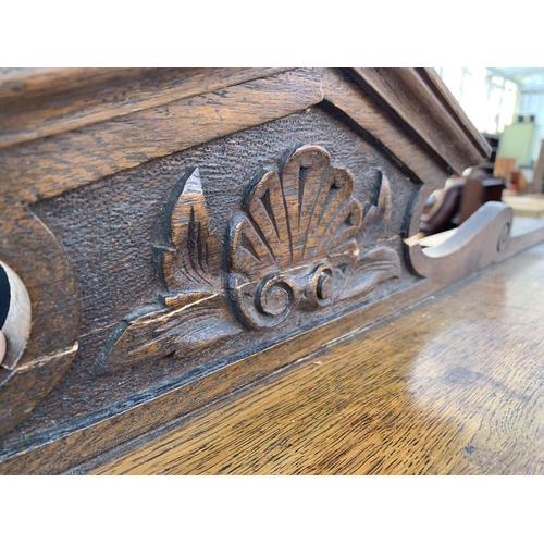 2484 - AN OAK ART NOUVEAU INFLUENCE SIDEBOARD WITH RAISED BACK, TWO DRAWERS AND TWO CUPBOARDS, 47