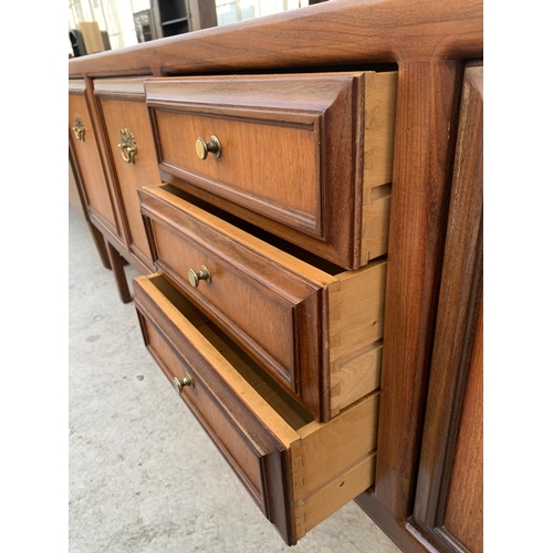 2498 - A RETRO TEAK SIDEBOARD WITH THREE CUPBOARDS AND THREE DRAWERS WITH BRASS HANDLES, ON OPEN BASE, 72