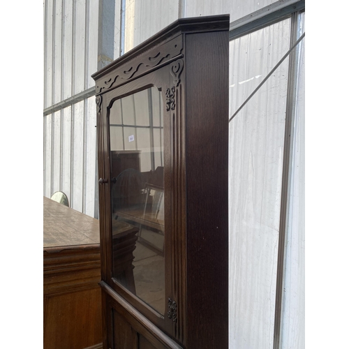 2502 - A MODERN OAK GLAZED CORNER CUPBOARD WITH CUPBOARD TO THE BASE