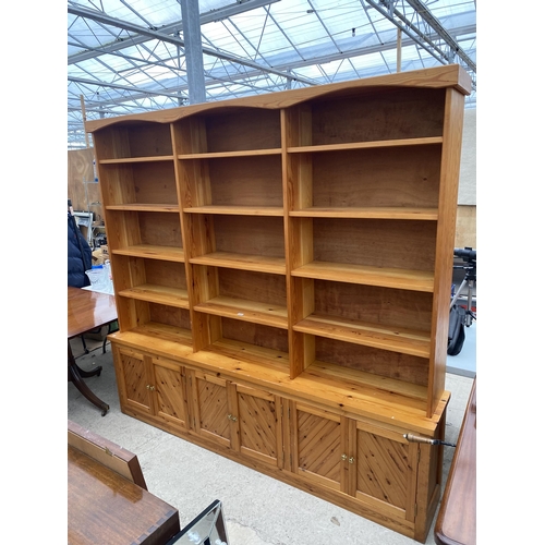 2556 - LARGE MODERN PINE FIFTEEN DIVISION OPEN SHELVES WITH SIX CUPBOARDS TO THE BASE, 91