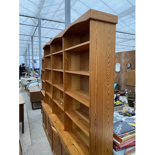 2556 - LARGE MODERN PINE FIFTEEN DIVISION OPEN SHELVES WITH SIX CUPBOARDS TO THE BASE, 91