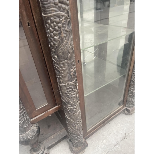 2597 - A HEAVILY CARVED VICTORIAN EBONISED BREAKFRONT DISPLAY CABINET WITH FOUR COLUMNS DEPICTING GRAPES AN... 