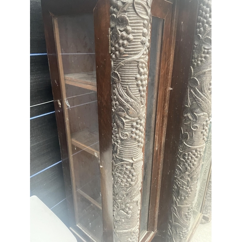 2597 - A HEAVILY CARVED VICTORIAN EBONISED BREAKFRONT DISPLAY CABINET WITH FOUR COLUMNS DEPICTING GRAPES AN... 