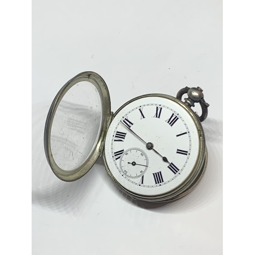 561 - A .900 GRADE SILVER OPEN FACED POCKET WATCH WITH KEY