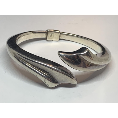 571 - A DESIGNER SILVER BANGLE MARKED ACE