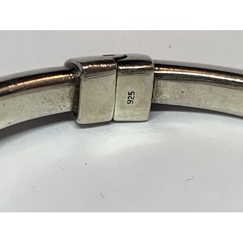 571 - A DESIGNER SILVER BANGLE MARKED ACE