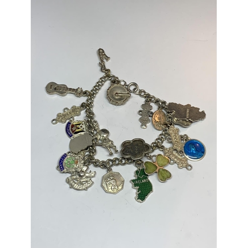 573 - A SILVER CHARM BRACELET WITH TWENTY CHARMS