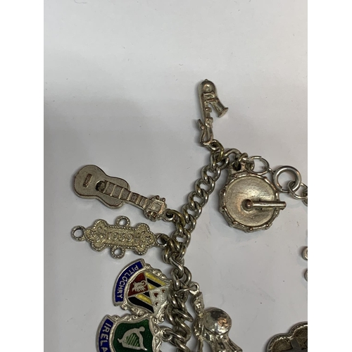 573 - A SILVER CHARM BRACELET WITH TWENTY CHARMS