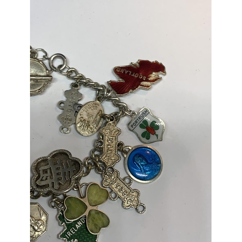 573 - A SILVER CHARM BRACELET WITH TWENTY CHARMS