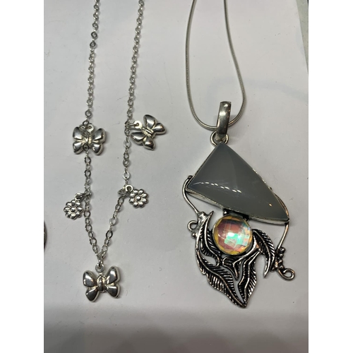 596 - FOUR SILVER NECKLACES WITH PENDANTS