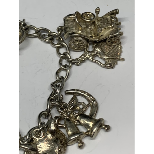 627 - A SILVER BRACELET WITH THIRTEEN CHARMS