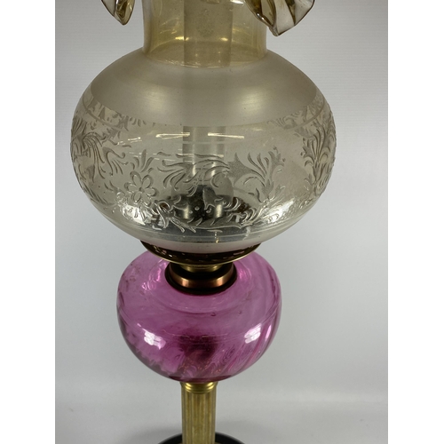 21 - A VINTAGE BRASS CORINTHIAN COLUMN OIL LAMP WITH CRANBERRY GLASS RESEVOIR, HEIGHT 71CM