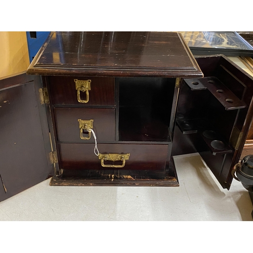 75 - AN ARTS & CRAFTS MAHOGANY SMOKERS CABINET WITH FOLD OUT DOORS AND INNER COMPARTMENTS, HEIGHT 32CM