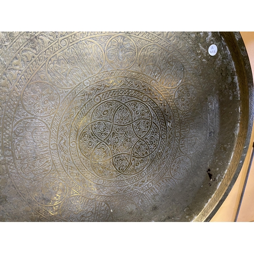 79 - A LARGE MIDDLE EASTERN BRASS CHARGER, DIAMETER 56CM