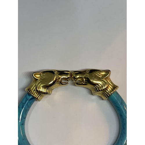 684 - AN ORNATE ANIMAL HEAD BANGLE