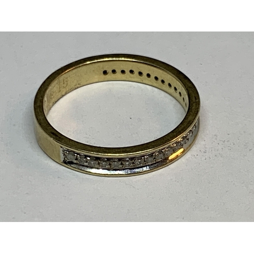 690 - A 9 CART GOLD RING WITH A BAND OF DIAMONDS SIZE K