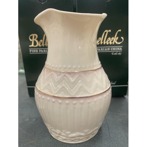 106 - THREE PIECES OF BELLEEK IN BOXES TO INCLUDE A PAIR OF 'LOTUS BLOSSOM SPILL' VASES AND A 'COLONIAL' V... 