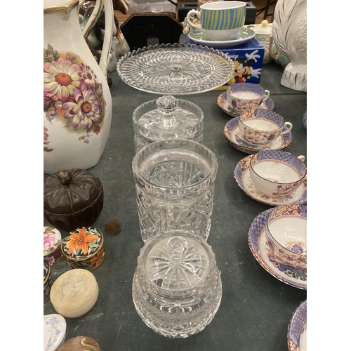 111 - A GLASS FOOTED CAKE STAND, PLUS THREE STORAGE JARS