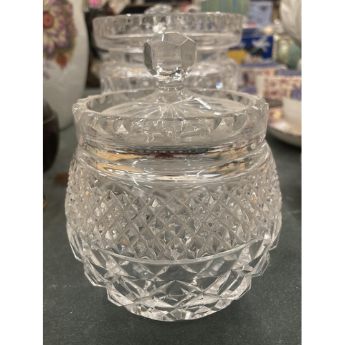 111 - A GLASS FOOTED CAKE STAND, PLUS THREE STORAGE JARS