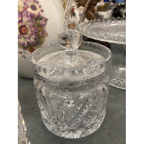 111 - A GLASS FOOTED CAKE STAND, PLUS THREE STORAGE JARS