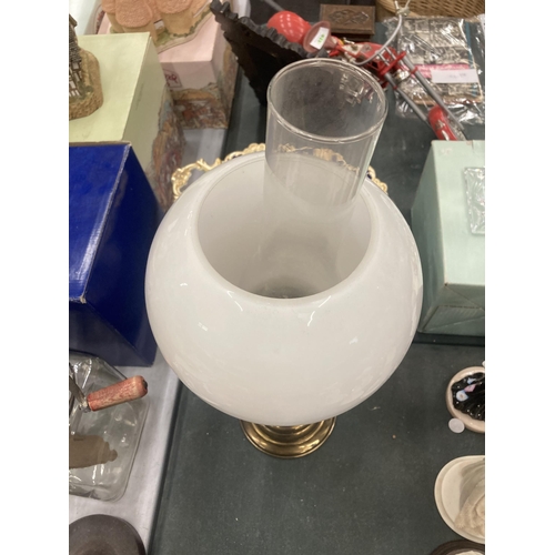 121 - A VINTAGE BRASS OIL LAMP WITH CLEAR GLASS CHIMNEY AND OPAQUE ROUND SHADE HEIGHT APPROX 50CM