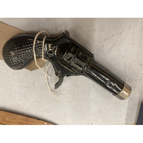 125 - A SMALL BLACK PAINTED TOY PISTOL, TOTAL LENGTH 12CM