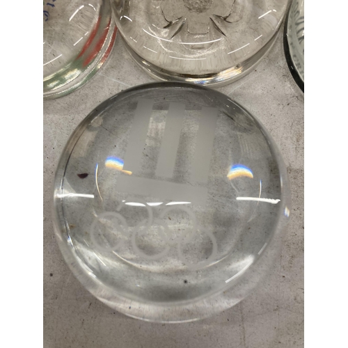 150 - A QUANTITY OF GLASS PAPERWEIGHTS WITH SPORTING THEMES