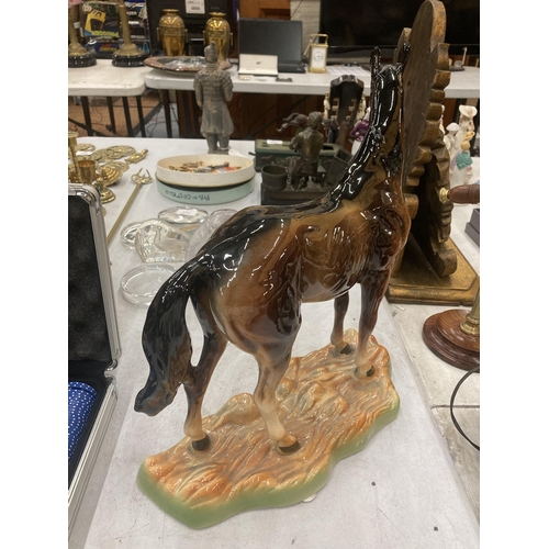 165 - A LARGE CERAMIC HORSE ON BASE MADE IN BELGIUM HEIGHT 36CM LENGTH 31CM