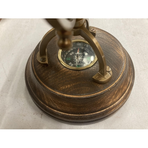 179 - A WORLD GLOBE WITH A COMPASS ON A WOODEN BASE HEIGHT APPROX 24CM