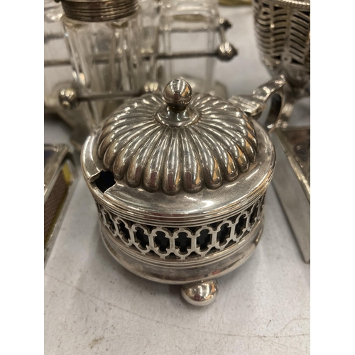 180 - A QUANTITY OF SILVER PLATED ITEMS TO INCLUDE A CRUET SET IN A STAND, MUSTARD AND PRESERVE POTS WITH ... 