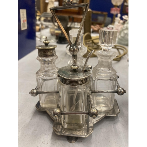 180 - A QUANTITY OF SILVER PLATED ITEMS TO INCLUDE A CRUET SET IN A STAND, MUSTARD AND PRESERVE POTS WITH ... 