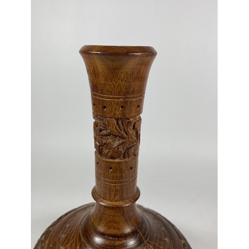 17 - A VINTAGE CARVED WOODEN INDIAN VASE, HEIGHT 23CM