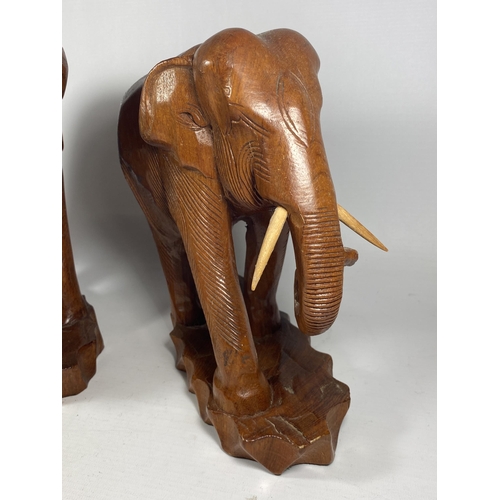 18 - A PAIR OF VINTAGE CARVED WOODEN TRIBAL FAMILY OF ELEPHANT FIGURES, HEIGTH 27CM