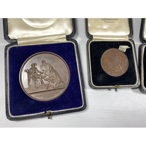 92 - A GROUP OF FOUR VINTAGE CASED BRONZE MEDALS