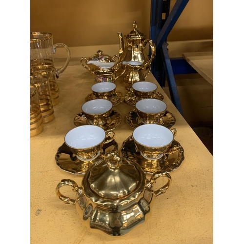 854 - A GOLD COLOURED GERMAN TEASET TO INCLUDE A TEAPOT, CREAM JUG, SUGAR BOWL, CUPS AND SAUCERS PLUS A FL... 