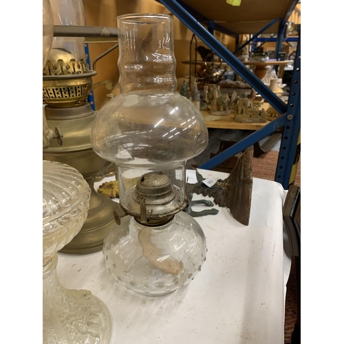 883 - THREE VINTAGE OIL LAMPS, ONE BRASS AND TWO GLASS